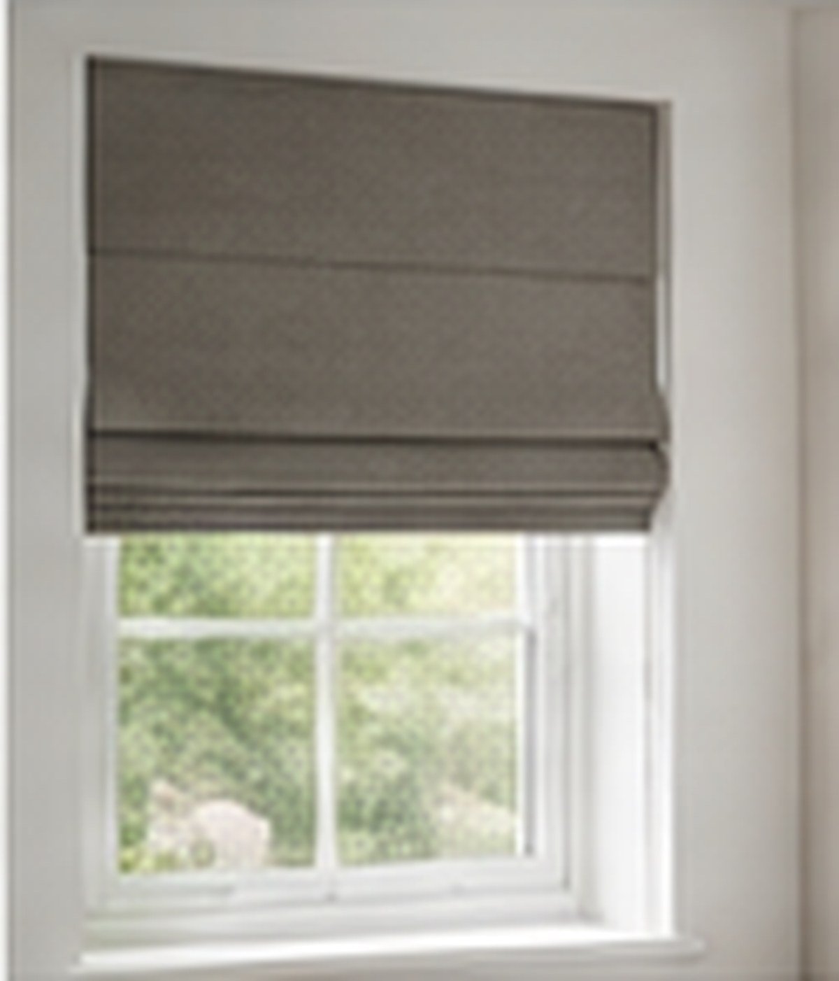Soft folded Roman fabric blind at a window