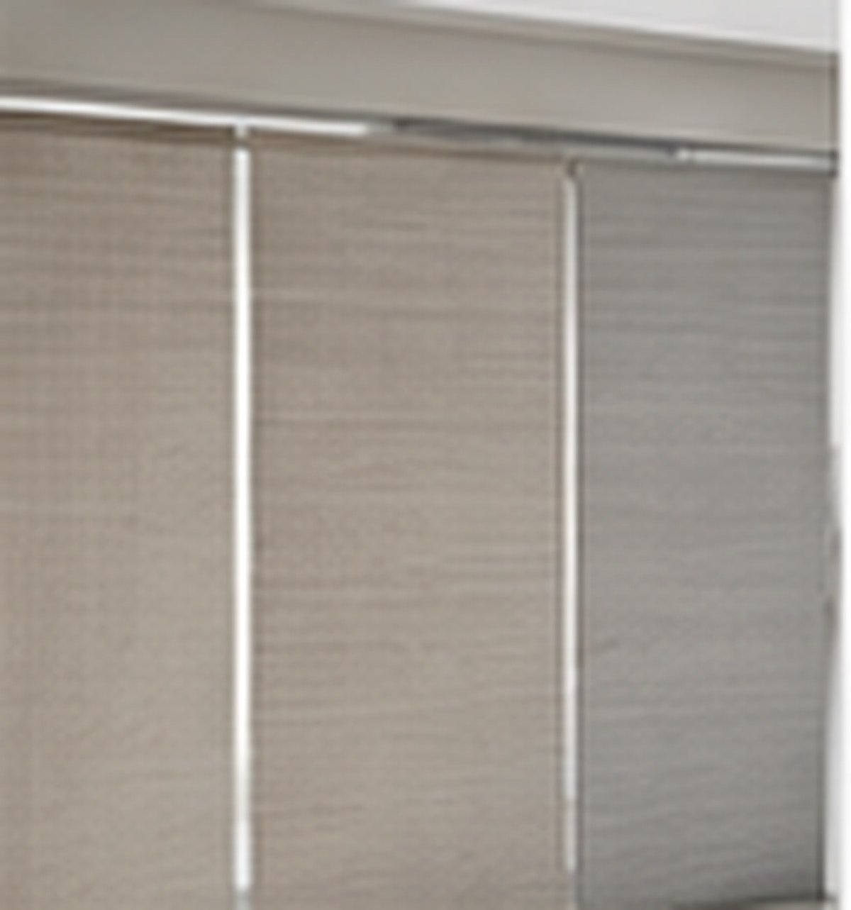 Fine woven screen fabric roller blind at a bright window
